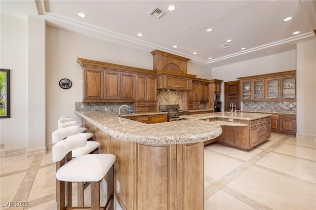 9801 Orient Express Ct, Las Vegas, NV 89145 - kitchen with recessed lighting, brown cabinetry, stainless steel stove, and a kitchen bar