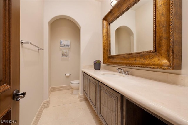 9801 Orient Express Ct, Las Vegas, NV 89145 - bathroom with vanity, baseboards, toilet, and tile patterned flooring