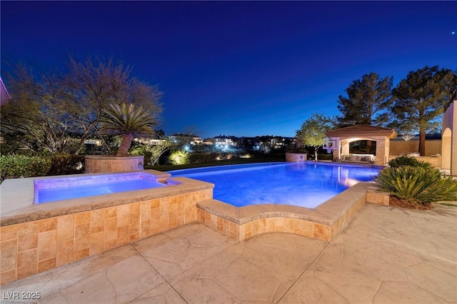 9801 Orient Express Ct, Las Vegas, NV 89145 - pool at night featuring a patio, an in ground hot tub, and an outdoor pool