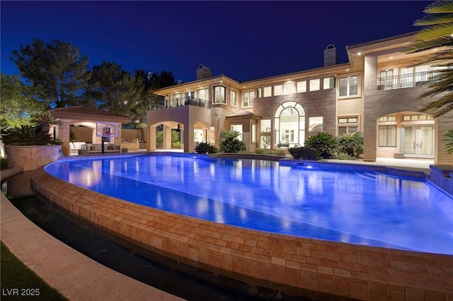 9801 Orient Express Ct, Las Vegas, NV 89145 - pool at night with an infinity pool, a gazebo, french doors, and a patio area
