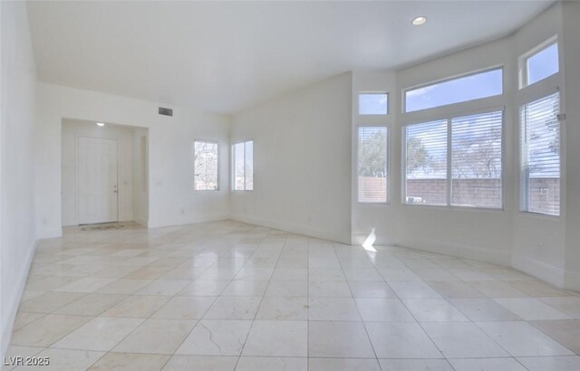 spare room featuring visible vents, recessed lighting, and baseboards