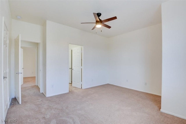 unfurnished bedroom with light colored carpet, baseboards, and ceiling fan