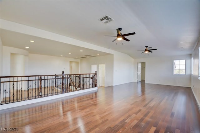 empty room featuring recessed lighting, wood finished floors, and visible vents