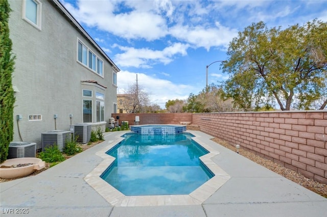 view of pool with central AC unit, a pool with connected hot tub, and a fenced backyard