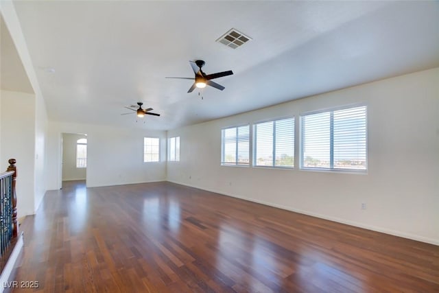 unfurnished room with visible vents, baseboards, wood finished floors, and a ceiling fan