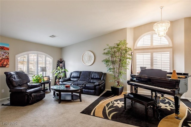 living area featuring a chandelier, visible vents, baseboards, and carpet floors