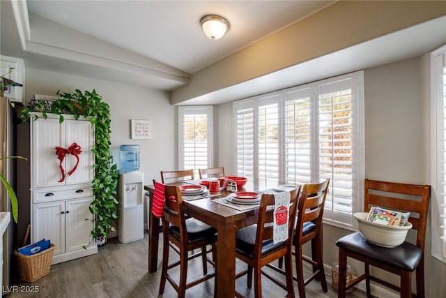 dining room with lofted ceiling and wood finished floors