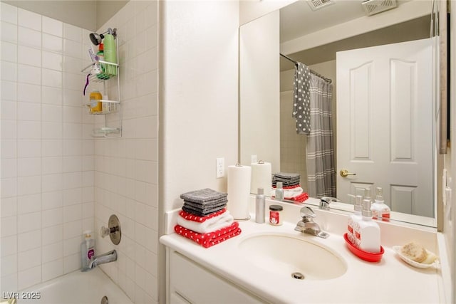 full bathroom featuring visible vents, vanity, and shower / tub combo