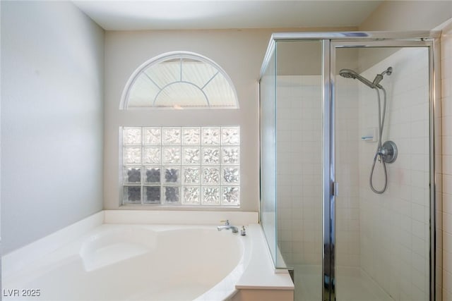 full bathroom with a shower stall and a garden tub