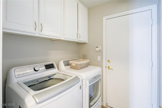 washroom with cabinet space and washing machine and dryer