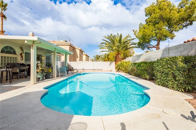 view of swimming pool with a fenced backyard, grilling area, a fenced in pool, and a patio