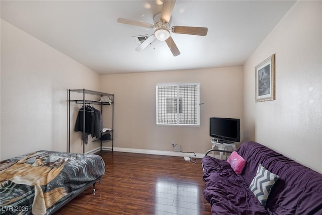 bedroom featuring visible vents, wood finished floors, baseboards, and ceiling fan