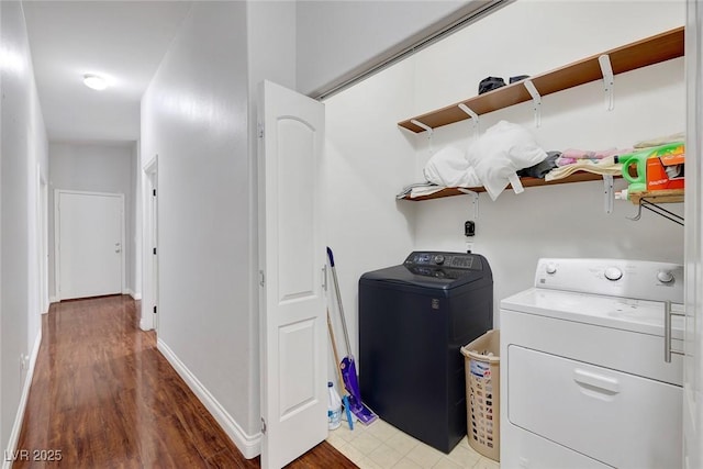 laundry area featuring laundry area, washer and dryer, and baseboards