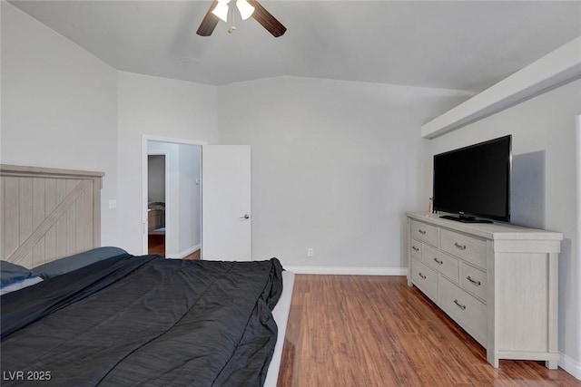 bedroom with a ceiling fan, lofted ceiling, baseboards, and wood finished floors