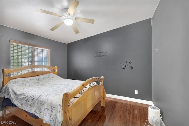 bedroom featuring wood finished floors, baseboards, and ceiling fan