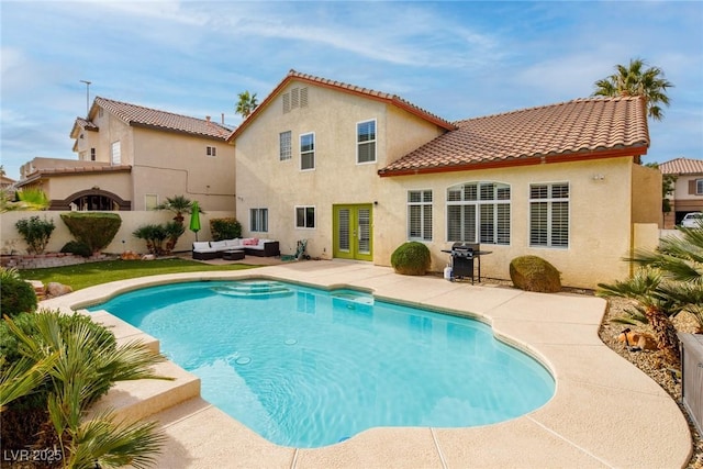 rear view of property featuring an outdoor living space, stucco siding, a fenced in pool, and a patio area