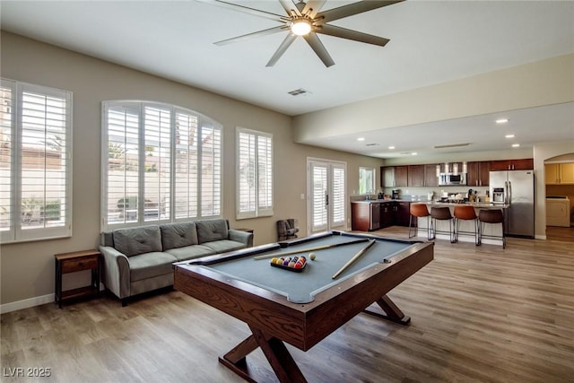 recreation room featuring light wood finished floors, visible vents, recessed lighting, and baseboards