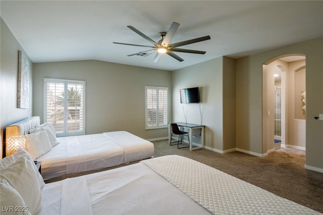 carpeted bedroom featuring multiple windows, arched walkways, and baseboards