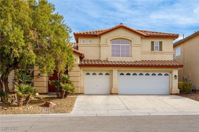 mediterranean / spanish house with stucco siding, concrete driveway, and an attached garage