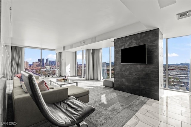 living area with visible vents and floor to ceiling windows