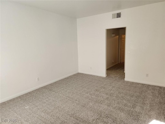 carpeted empty room with visible vents and baseboards