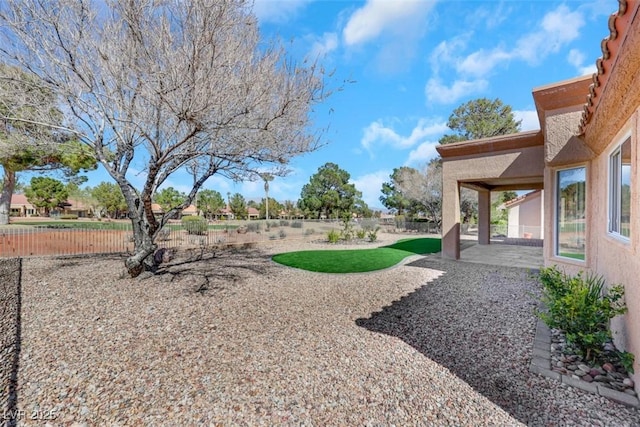 view of yard featuring a patio area and fence