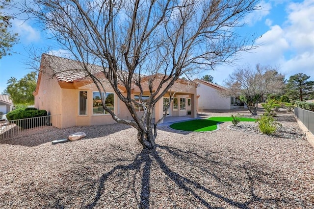 back of house featuring stucco siding, a fenced backyard, and a patio area