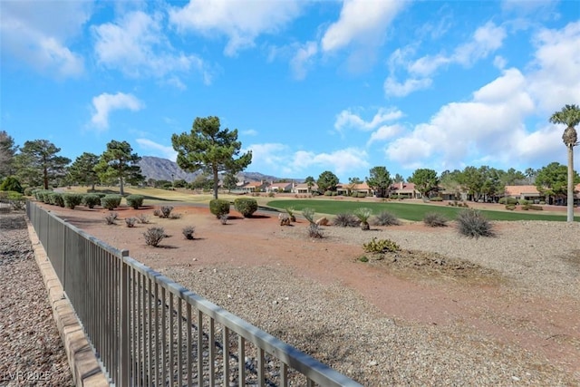 view of yard with fence and a mountain view