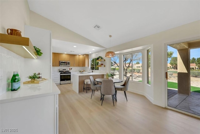 dining area featuring visible vents, light wood finished floors, baseboards, recessed lighting, and vaulted ceiling