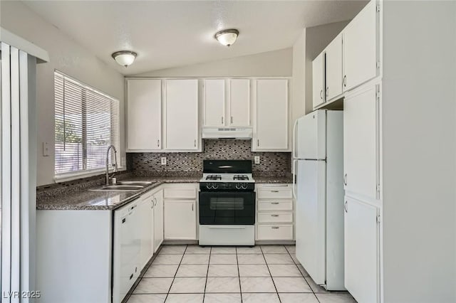 kitchen with white appliances, light tile patterned flooring, a sink, under cabinet range hood, and dark countertops