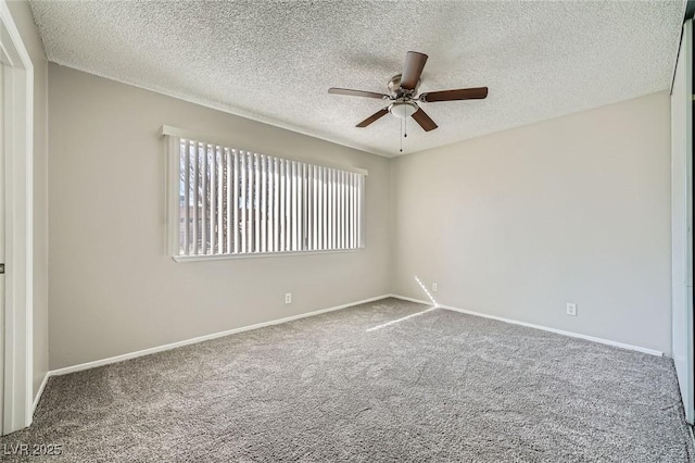 carpeted empty room with a textured ceiling, baseboards, and a ceiling fan