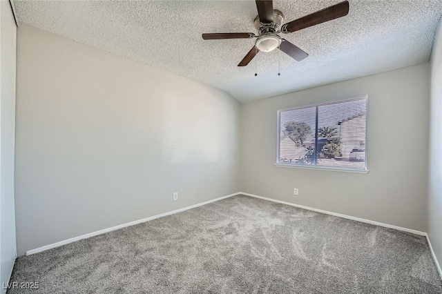 carpeted empty room with a ceiling fan, baseboards, and a textured ceiling