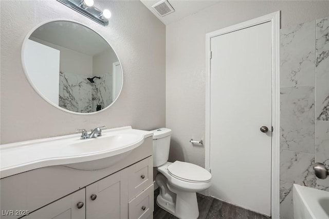 full bath with visible vents, toilet, vanity, and wood finished floors