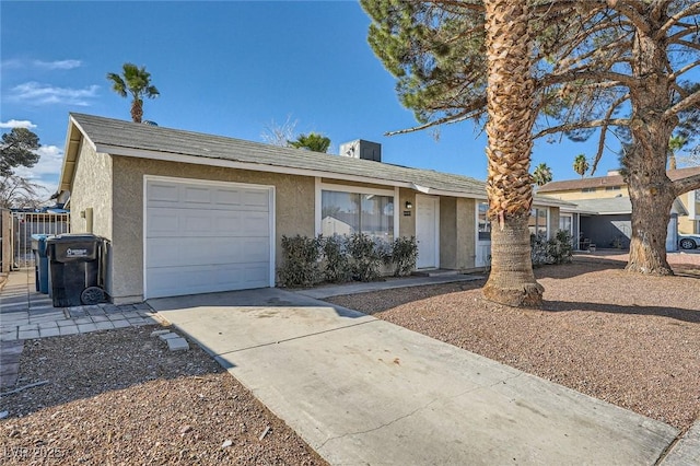 single story home featuring stucco siding, a garage, and driveway