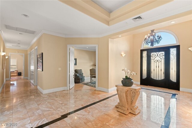 entrance foyer featuring an inviting chandelier, visible vents, baseboards, and marble finish floor