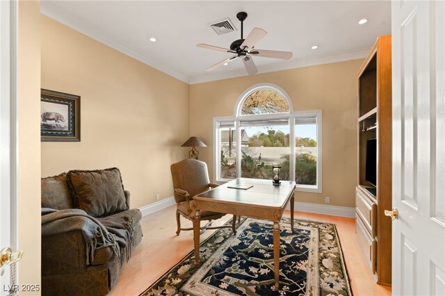 office space featuring light wood finished floors, visible vents, crown molding, and baseboards