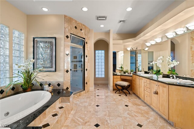 full bath with a sink, visible vents, a garden tub, and a stall shower