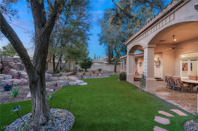 view of yard with a patio area, a fenced backyard, and ceiling fan