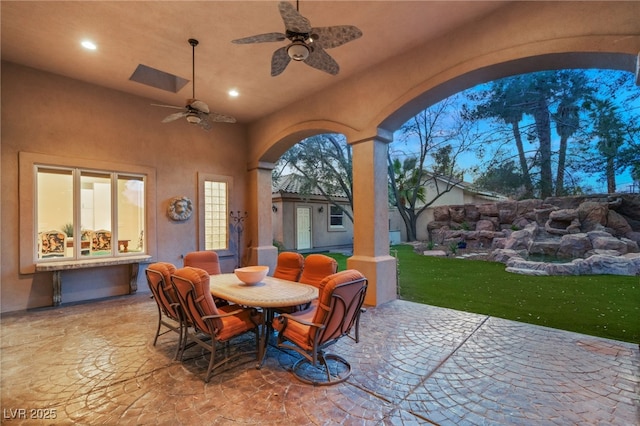 view of patio featuring ceiling fan and outdoor dining space