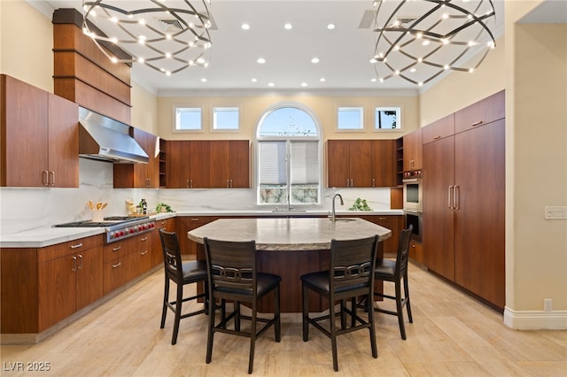 kitchen with ventilation hood, crown molding, a center island with sink, appliances with stainless steel finishes, and open shelves