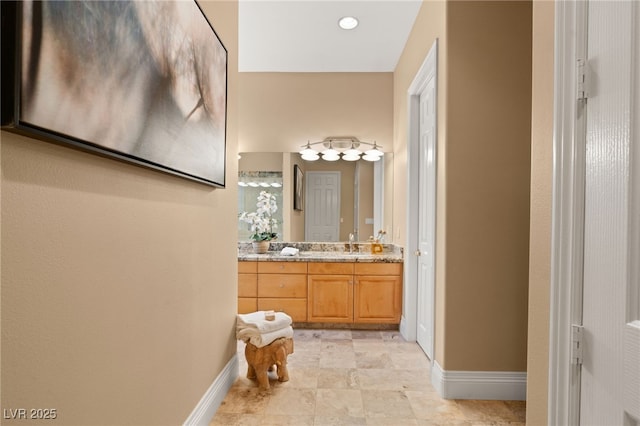 bathroom with vanity and baseboards