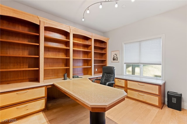 office area featuring baseboards and light wood finished floors