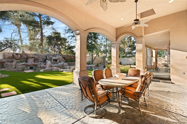 view of patio with outdoor dining area, a fenced backyard, and a ceiling fan