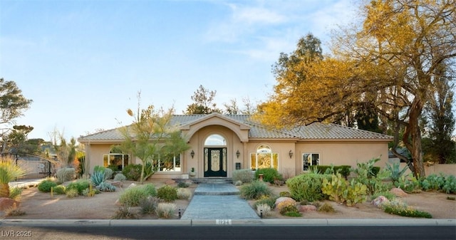 view of front of property featuring a tile roof and stucco siding