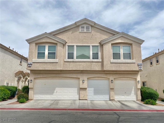 view of front of property featuring an attached garage and stucco siding