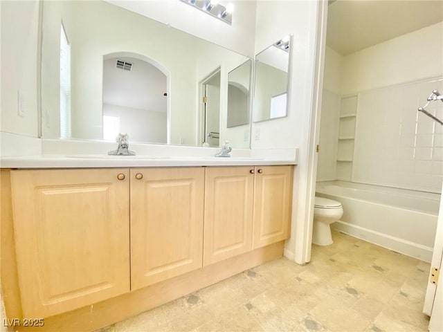 bathroom with visible vents, toilet, double vanity, a sink, and tub / shower combination