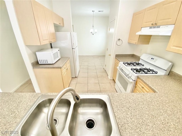 kitchen featuring light brown cabinetry, under cabinet range hood, a sink, white appliances, and light countertops