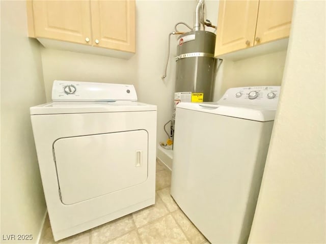 laundry room featuring washer and clothes dryer, strapped water heater, cabinet space, and light tile patterned floors