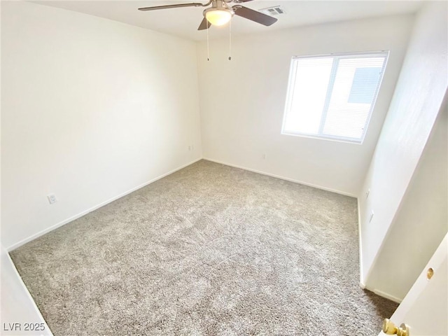 spare room featuring visible vents, a ceiling fan, baseboards, and carpet floors