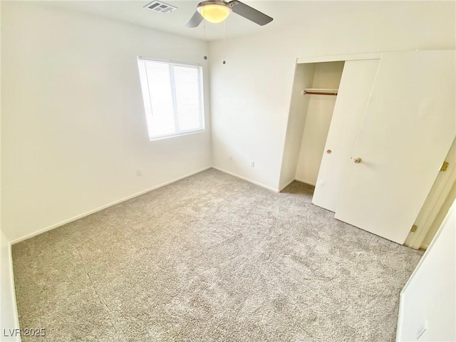 unfurnished bedroom featuring visible vents, baseboards, carpet, a closet, and a ceiling fan